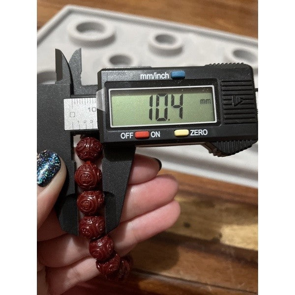 Cinnabar bracelet with chinese carving