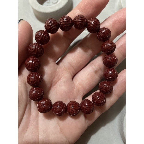 Cinnabar bracelet with chinese carving