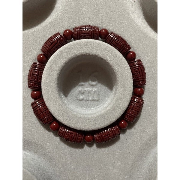 cinnabar bracelet barrel with carving