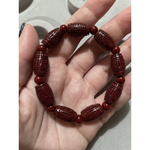 cinnabar bracelet barrel with carving